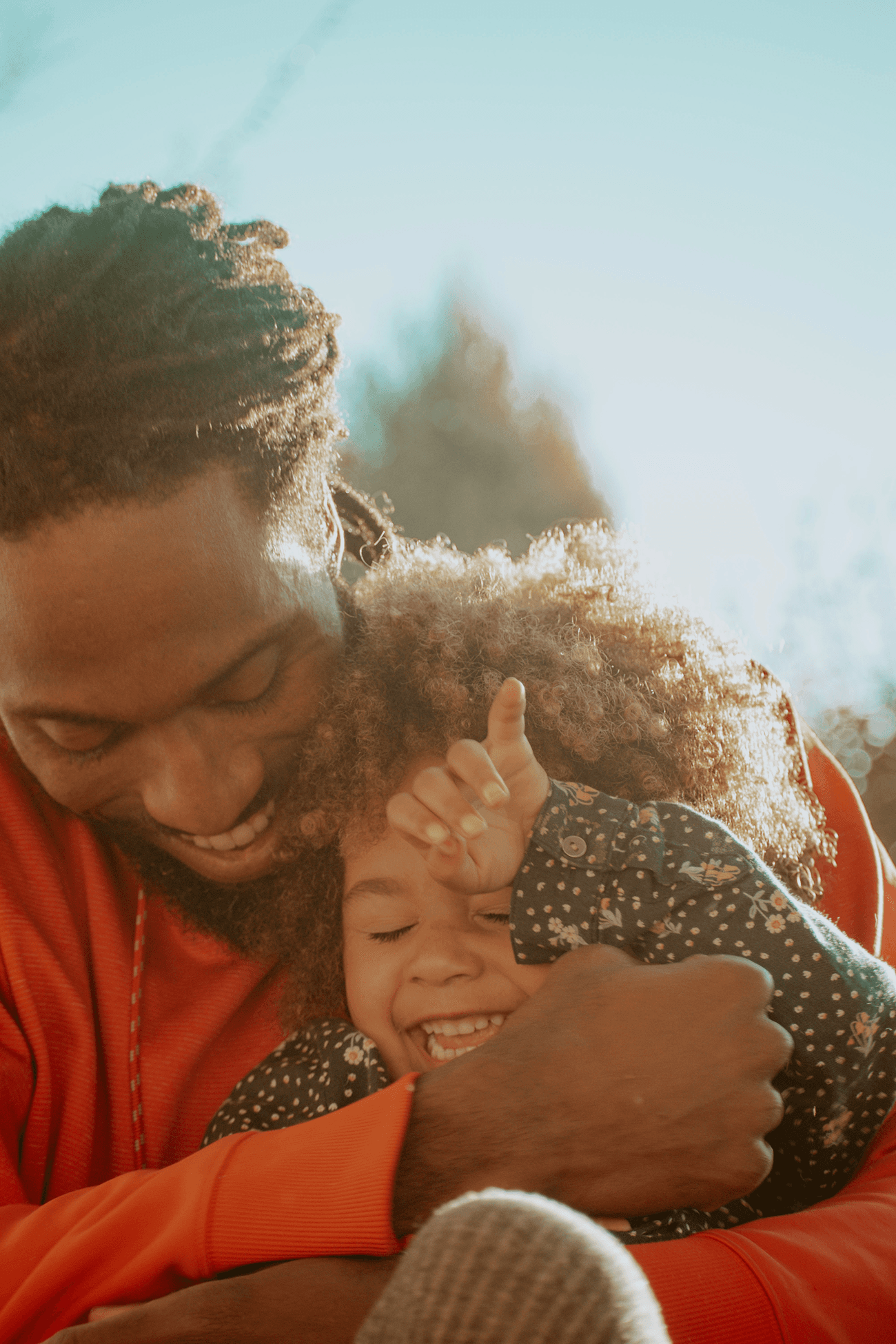 A father holding his young daughter