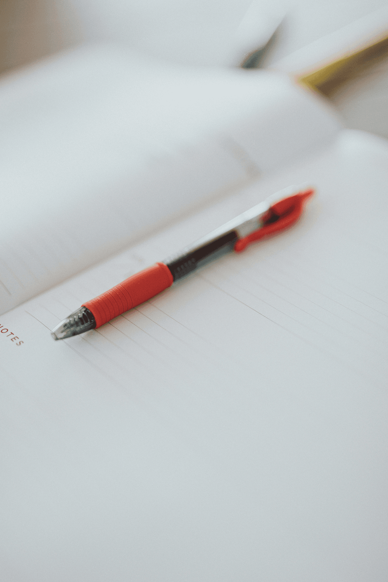 A pen resting on an open notebook