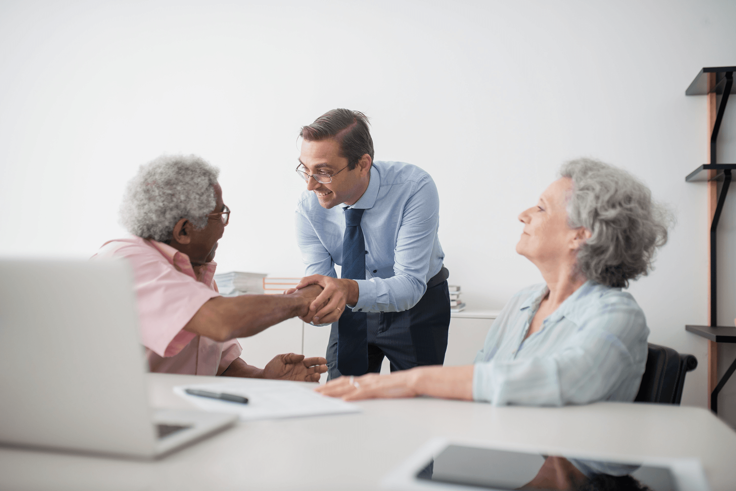 A happy old couple with an insurance advisor